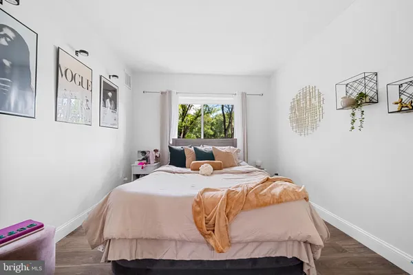 a bedroom with a bed and wall painting