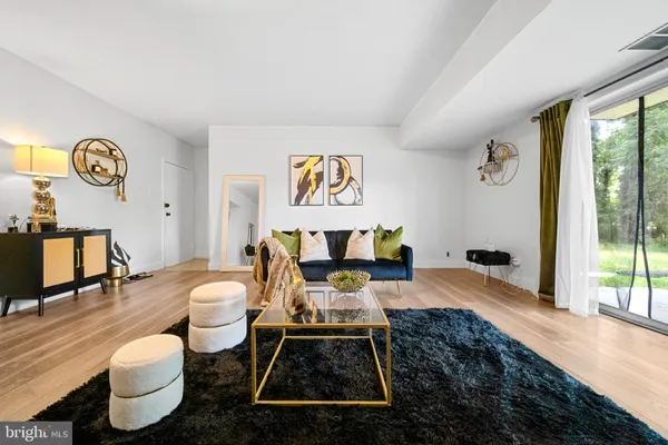 a living room with furniture and a floor to ceiling window