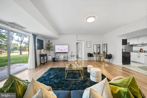 a living room with furniture and a floor to ceiling window