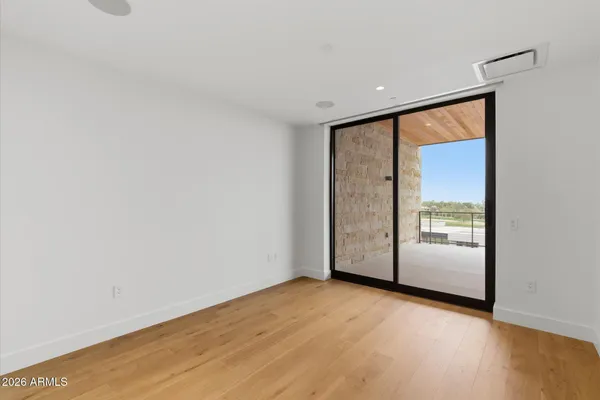 a bedroom with a large bed and a large window