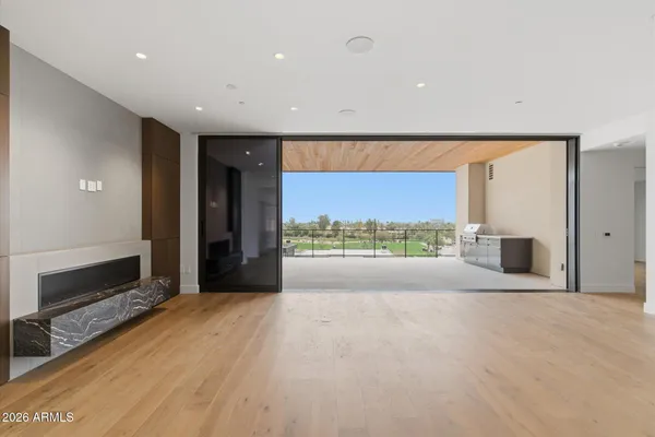 a living room with furniture a flat screen tv and a large window