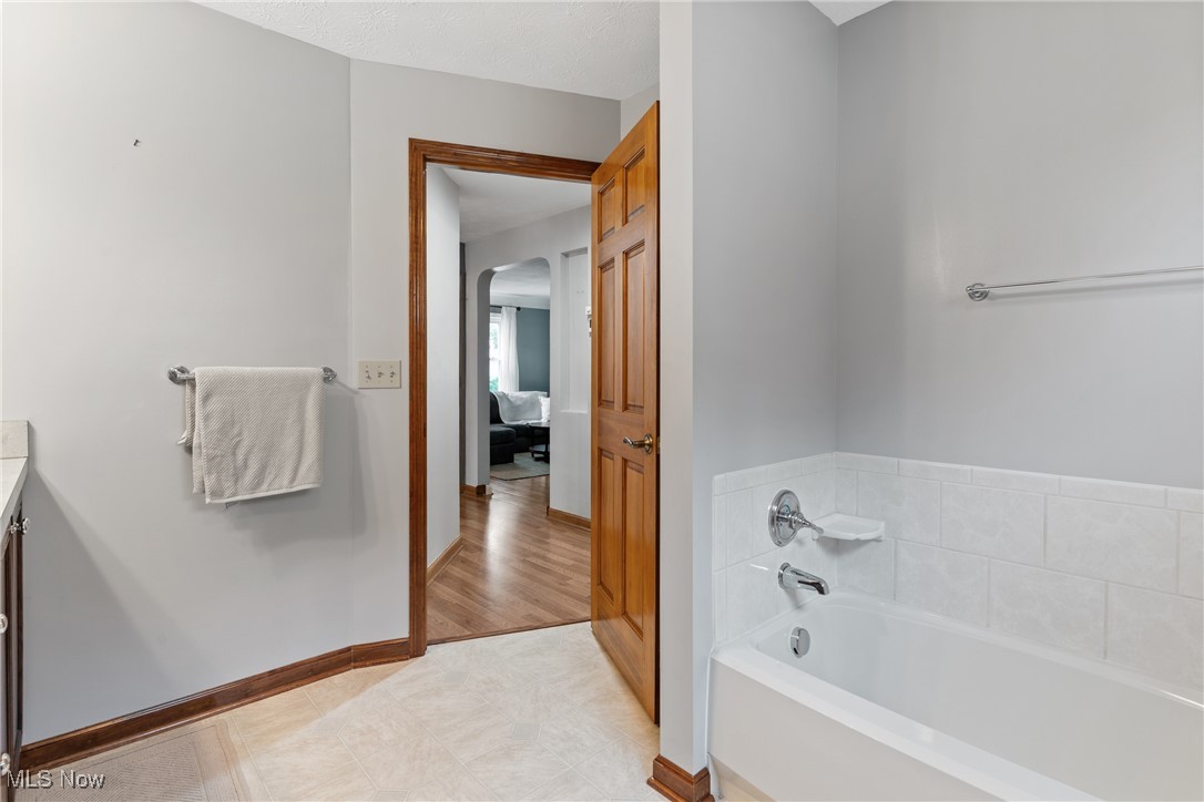 7514 Spring Garden Road Cleveland, OH 44129 - Photo 14 of 30 Main floor full bath with vanity, a stall shower, and light tile patterned flooring