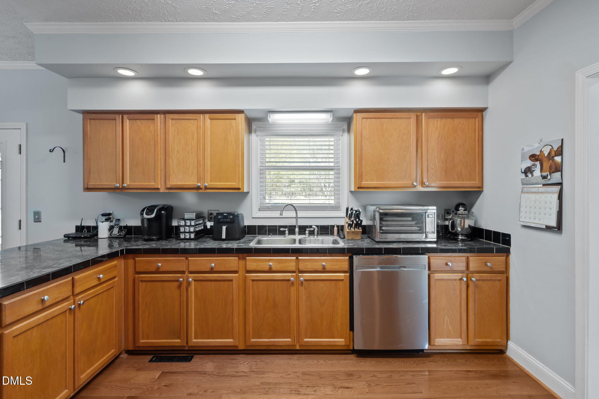 236 Dirgie Mine Road Roxboro, NC 27574 - Photo 23 of 55 a kitchen with granite countertop white cabinets sink and window