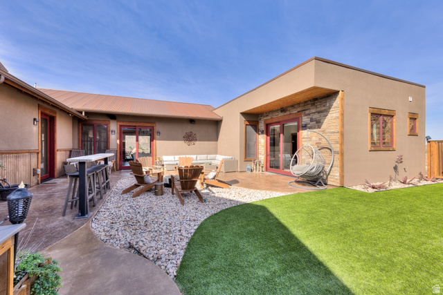 4173 Shadowfax Run, Unit 5 Moab, UT 84532 - Photo 38 of 41 Rear courtyard featuring doors to inside, bar seating, and outdoor lounge area
