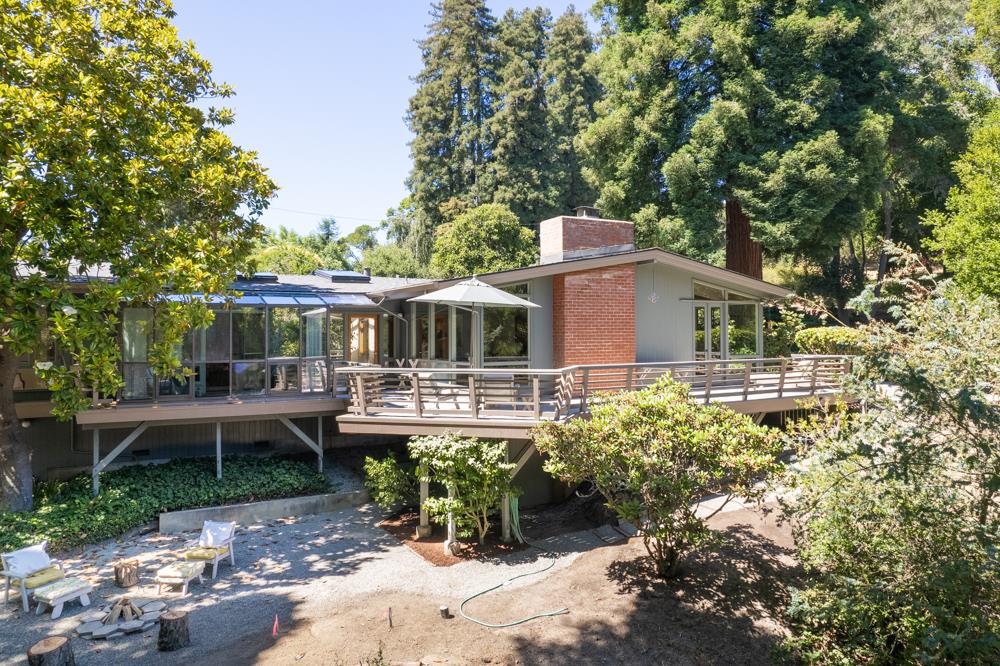 a front view of house with yard table and chairs