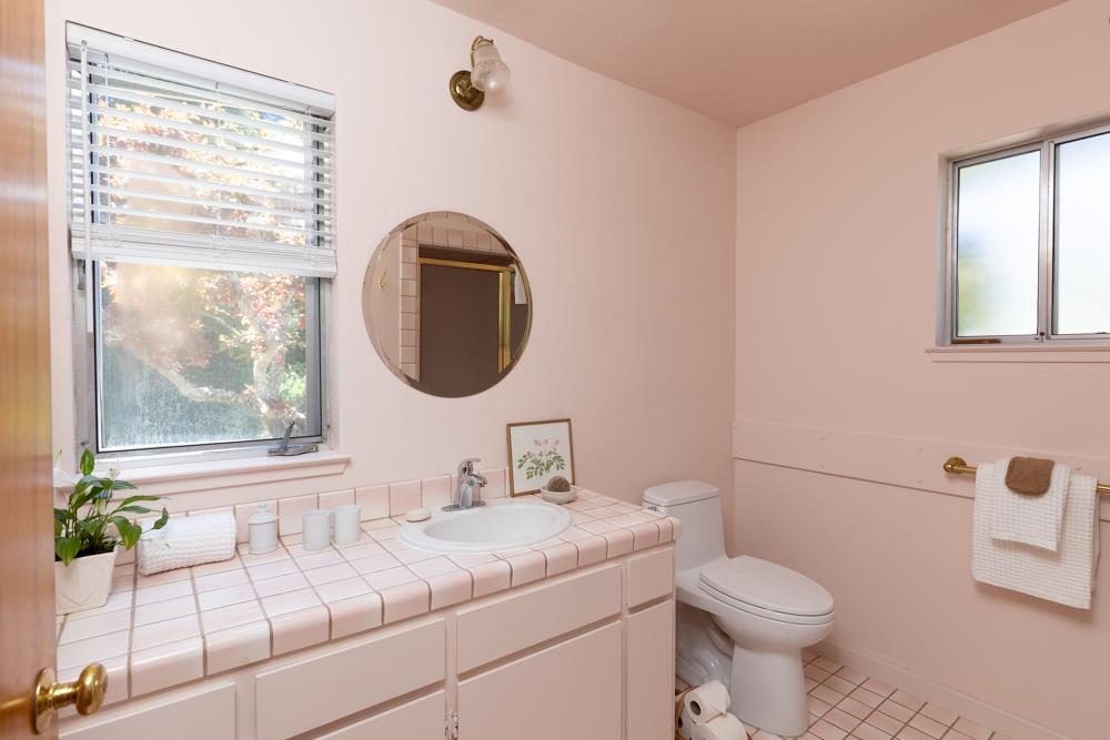 275 Aptos School Road Aptos, CA 95003 - Photo 17 of 45 a bathroom with a granite countertop sink mirror and toilet