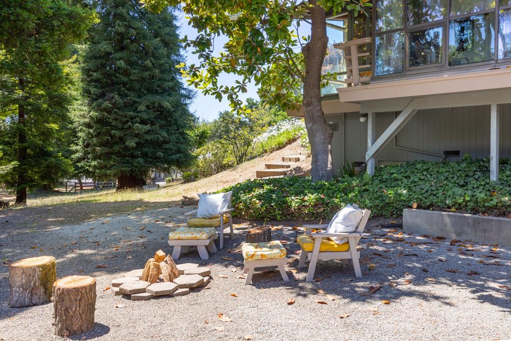 275 Aptos School Road Aptos, CA 95003 - Photo 20 of 45 a view of a patio with table and chairs and wooden fence