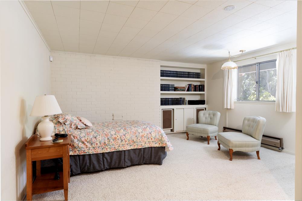 275 Aptos School Road Aptos, CA 95003 - Photo 25 of 45 a bedroom with furniture and a book shelf