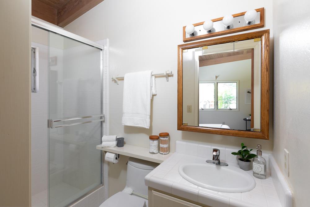 275 Aptos School Road Aptos, CA 95003 - Photo 26 of 45 a bathroom with a sink a toilet and a mirror