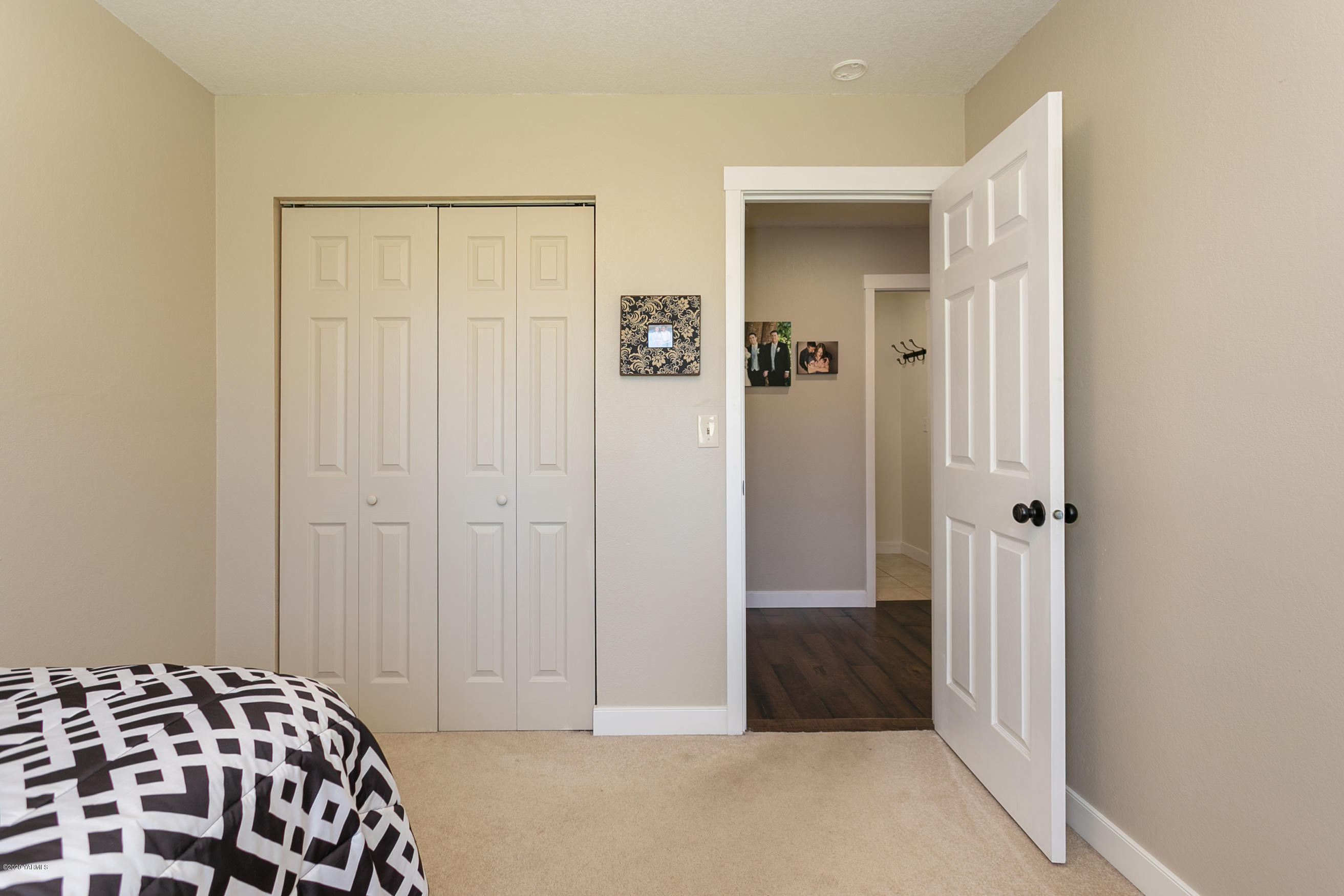 601 Brewer Road Grandview, WA 98930 - Photo 14 of 32 a bedroom with a bed and a walk in closet