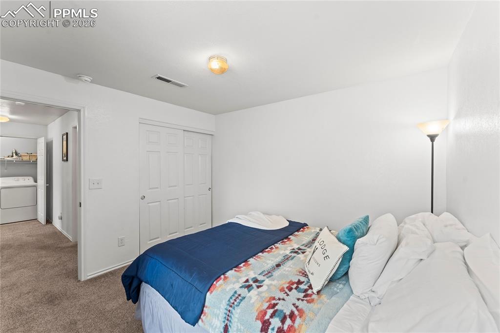 3976 Riviera Grove, Unit 203 Colorado Springs, CO 80922 - Photo 30 of 45 a bedroom with a bed and a lamp
