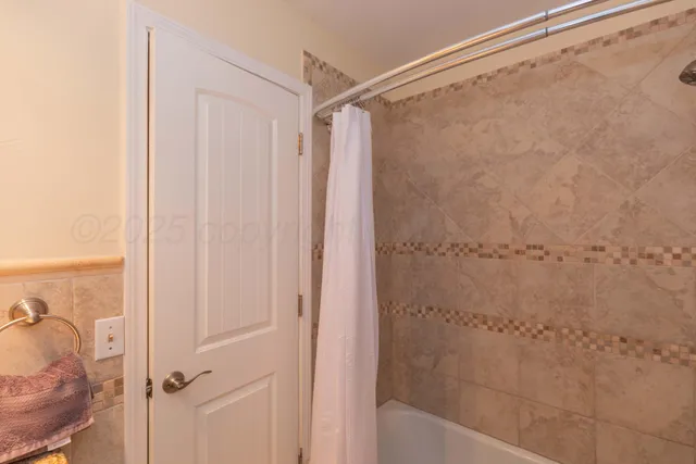 a front view of a house with a garden and trees