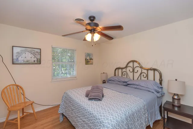 a kitchen with a sink a stove cabinets and a window