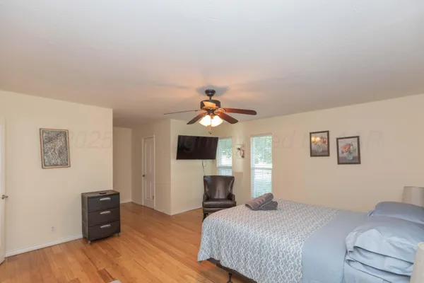 a bedroom with a bed and a flat screen tv