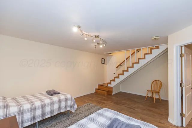 a bedroom with a bed and a flat screen tv