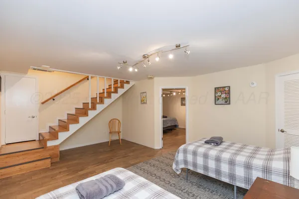 a bedroom with a bed and a chandelier