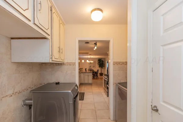 a bedroom with a bed a dresser with wooden floor