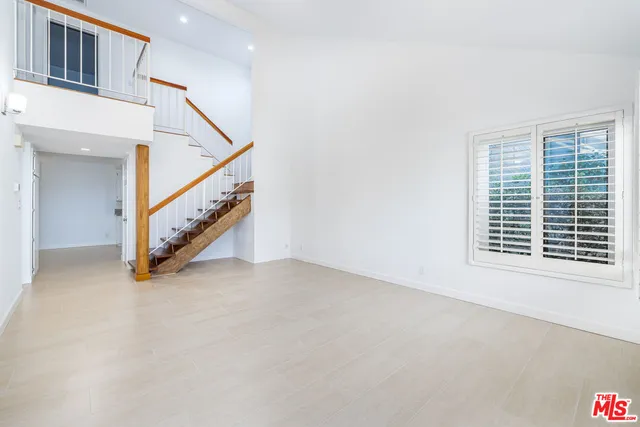 a view of an empty room with stairs