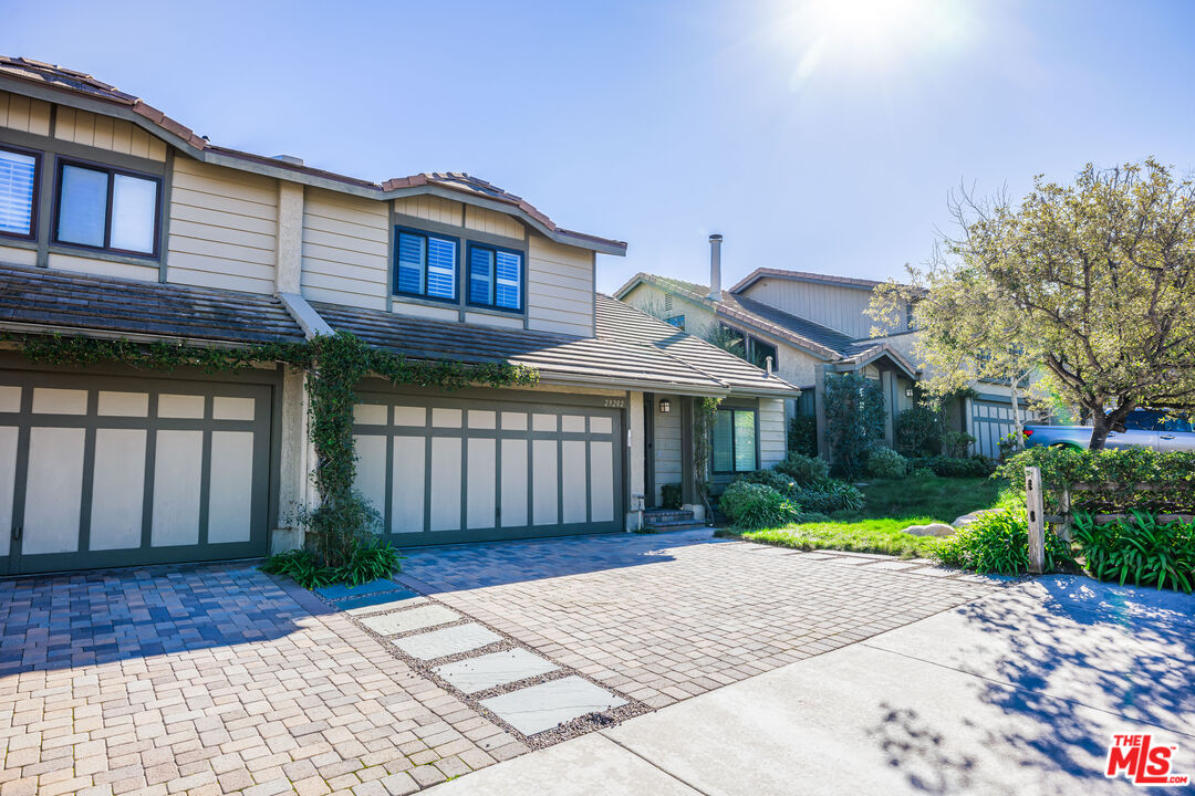 29202 Heathercliff Road Malibu, CA 90265 - Photo 2 of 20 a front view of a house with a yard and potted plants