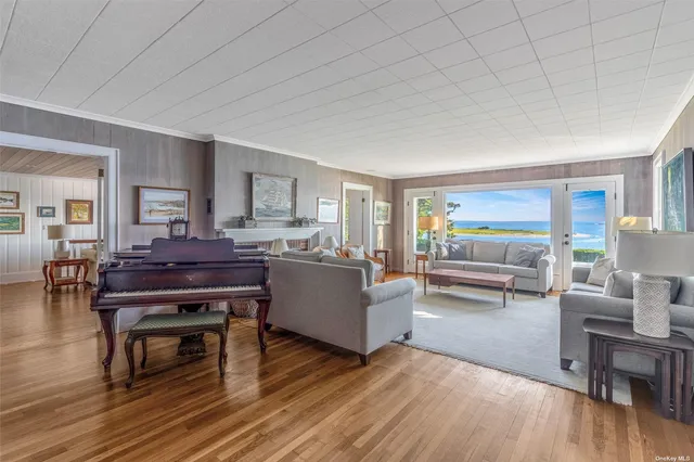 a living room with furniture and a piano table