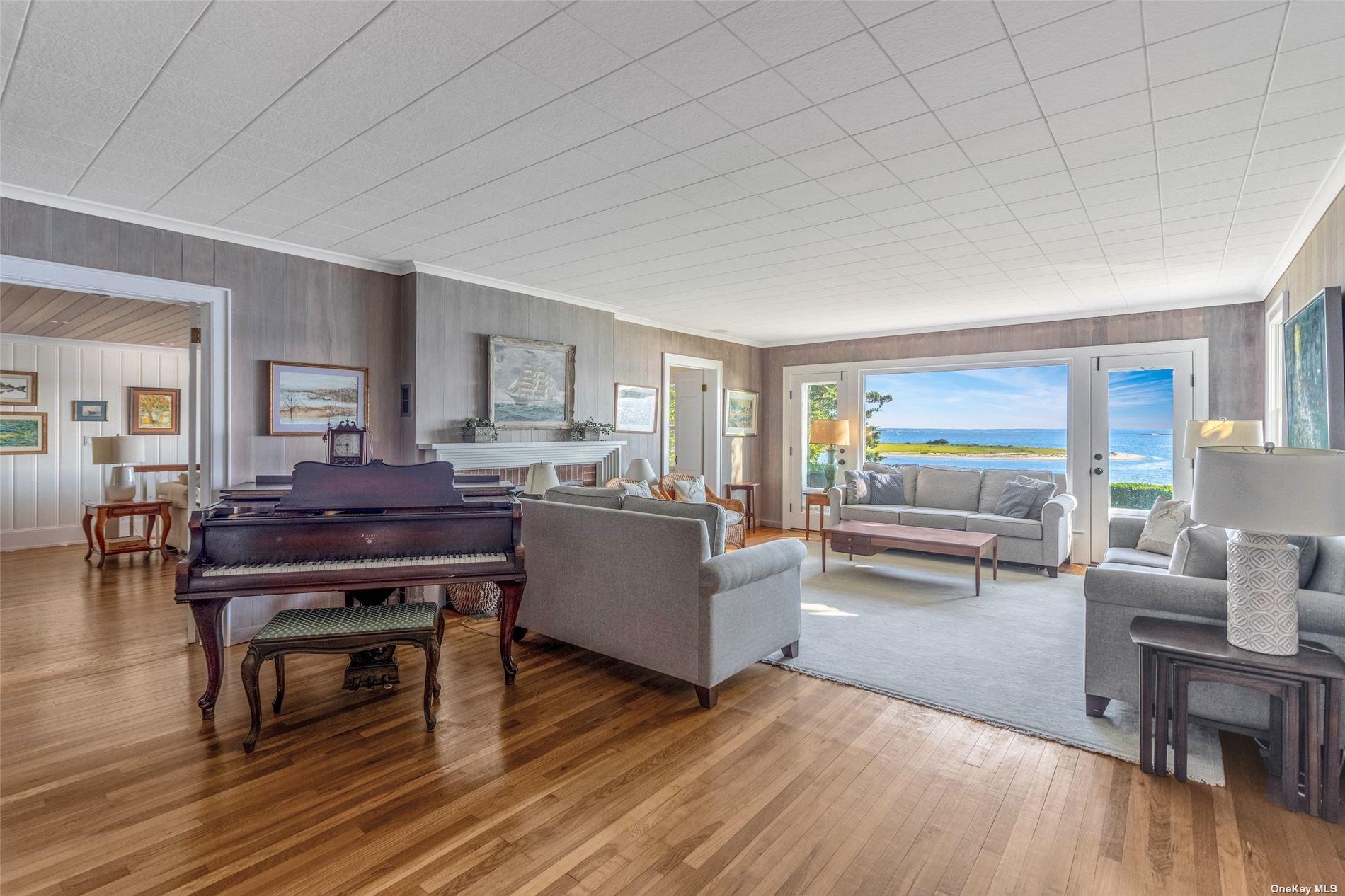 930 West Cove Road Cutchogue, NY 11935 - Photo 2 of 34 a living room with furniture and a piano table