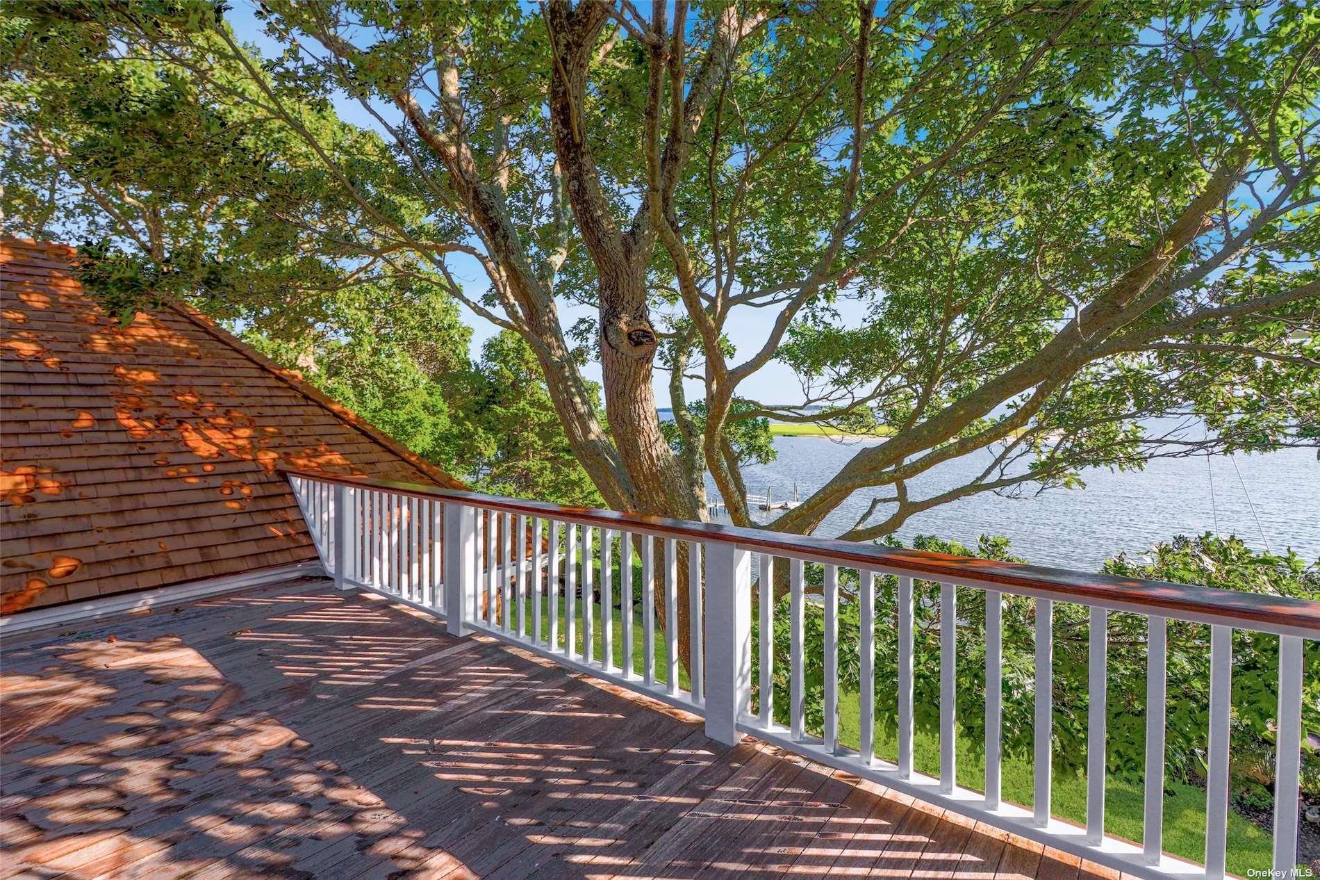 930 West Cove Road Cutchogue, NY 11935 - Photo 23 of 34 a balcony with wooden floor and trees