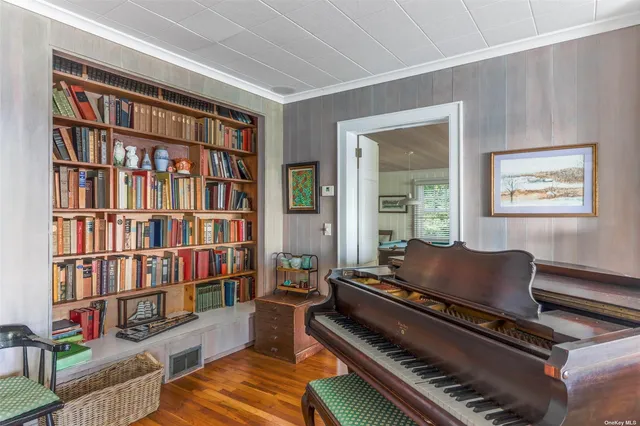 a living room with furniture and a book shelf