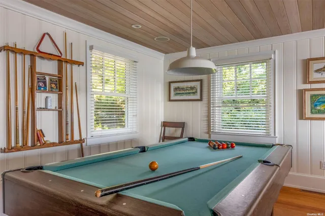 a room with furniture pool table and windows