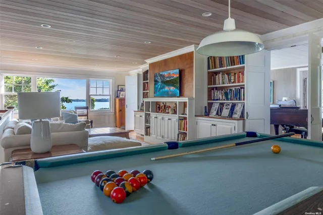 a living room with furniture and a book shelf