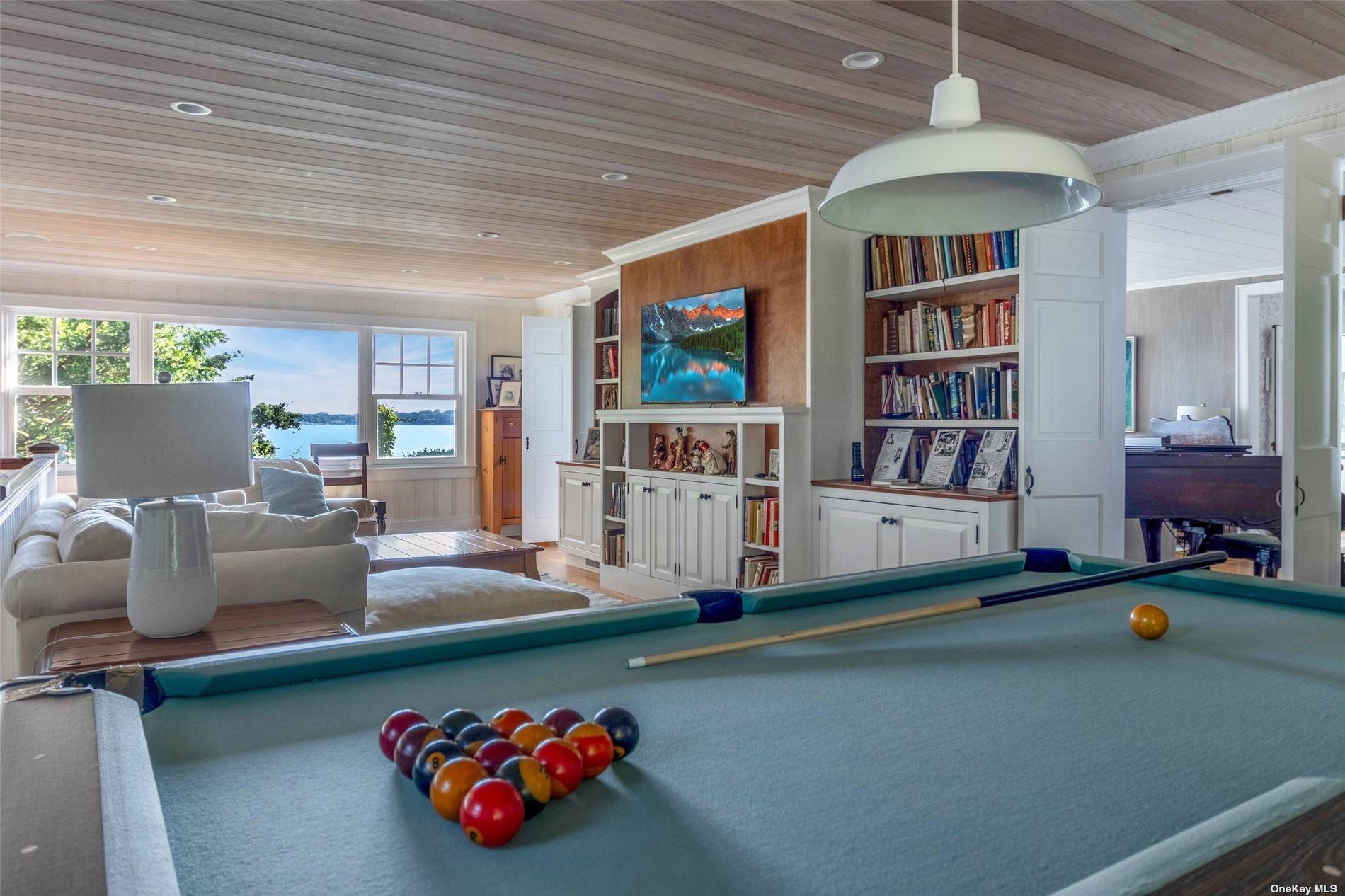 930 West Cove Road Cutchogue, NY 11935 - Photo 6 of 34 a living room with furniture and a book shelf