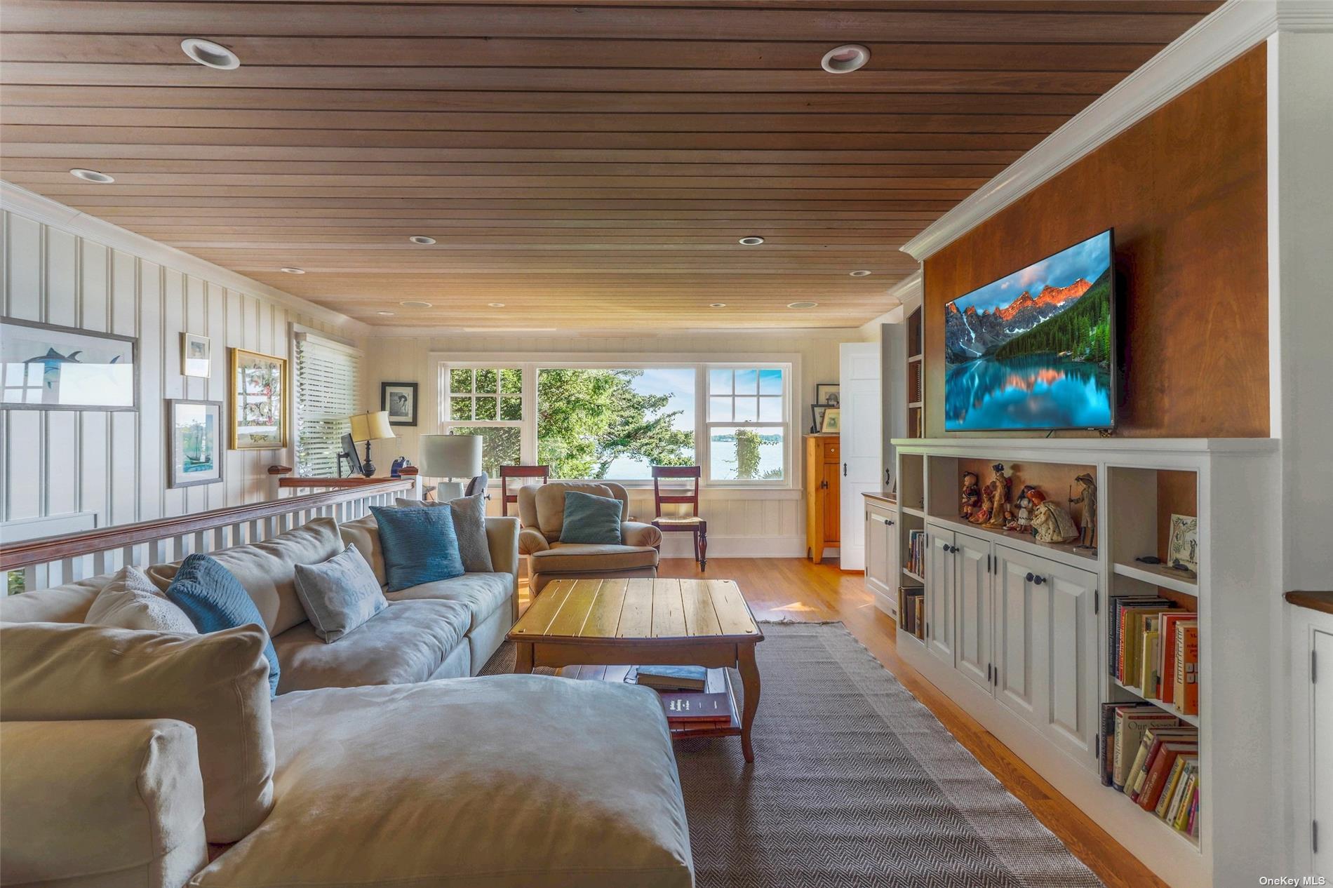 930 West Cove Road Cutchogue, NY 11935 - Photo 8 of 34 a living room with furniture wooden floor and a flat screen tv