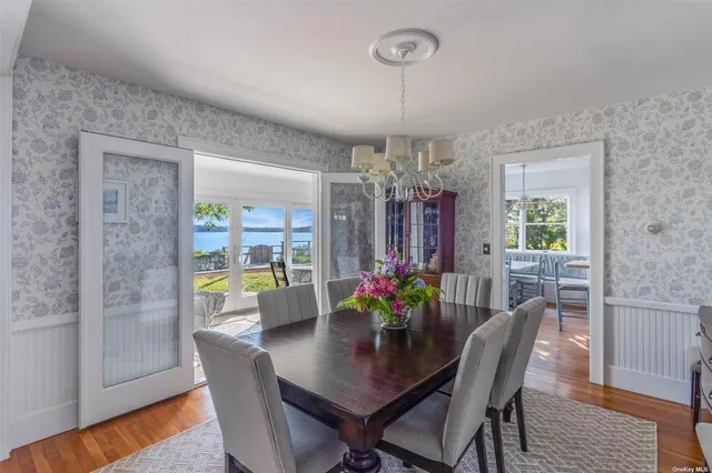 a view of a dining room with furniture and chandelier