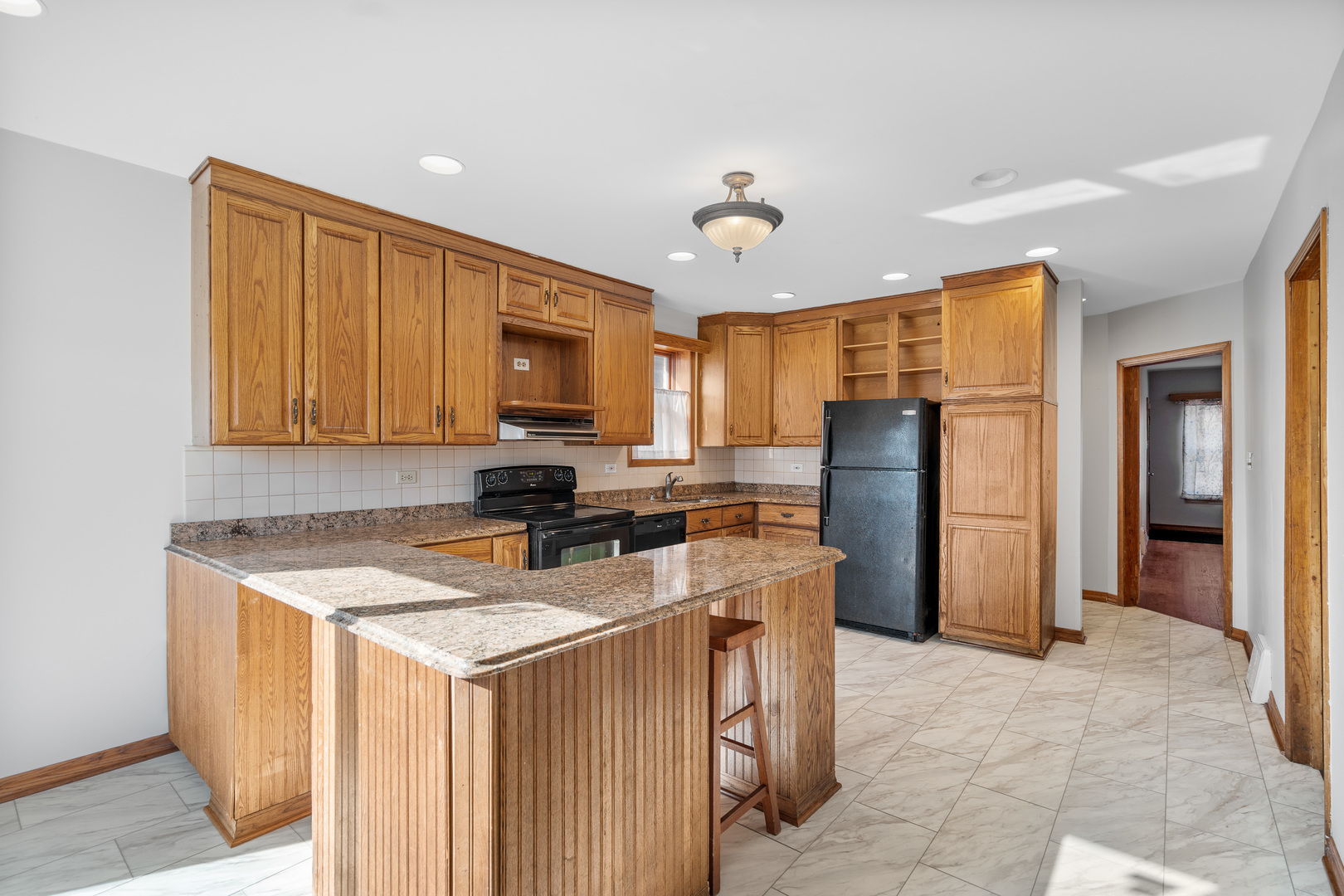 7845 45th Street Lyons, IL 60534 - Photo 11 of 31 a kitchen with stainless steel appliances granite countertop a refrigerator stove microwave and sink