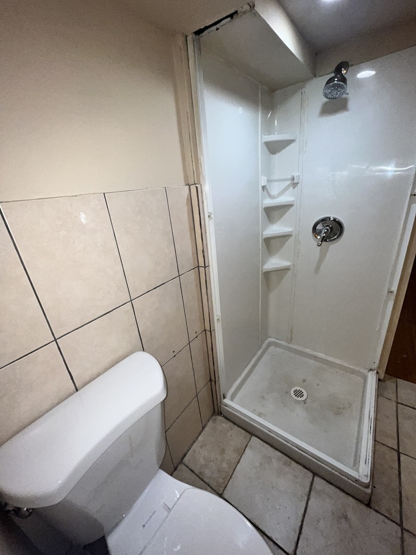 7845 45th Street Lyons, IL 60534 - Photo 24 of 31 a bathroom with a tub and a shower