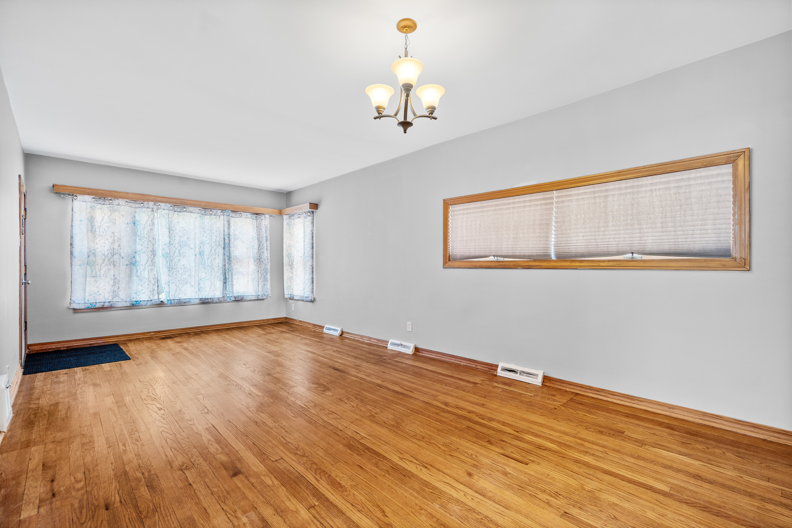 7845 45th Street Lyons, IL 60534 - Photo 3 of 31 a view of an empty room with wooden floor and a window
