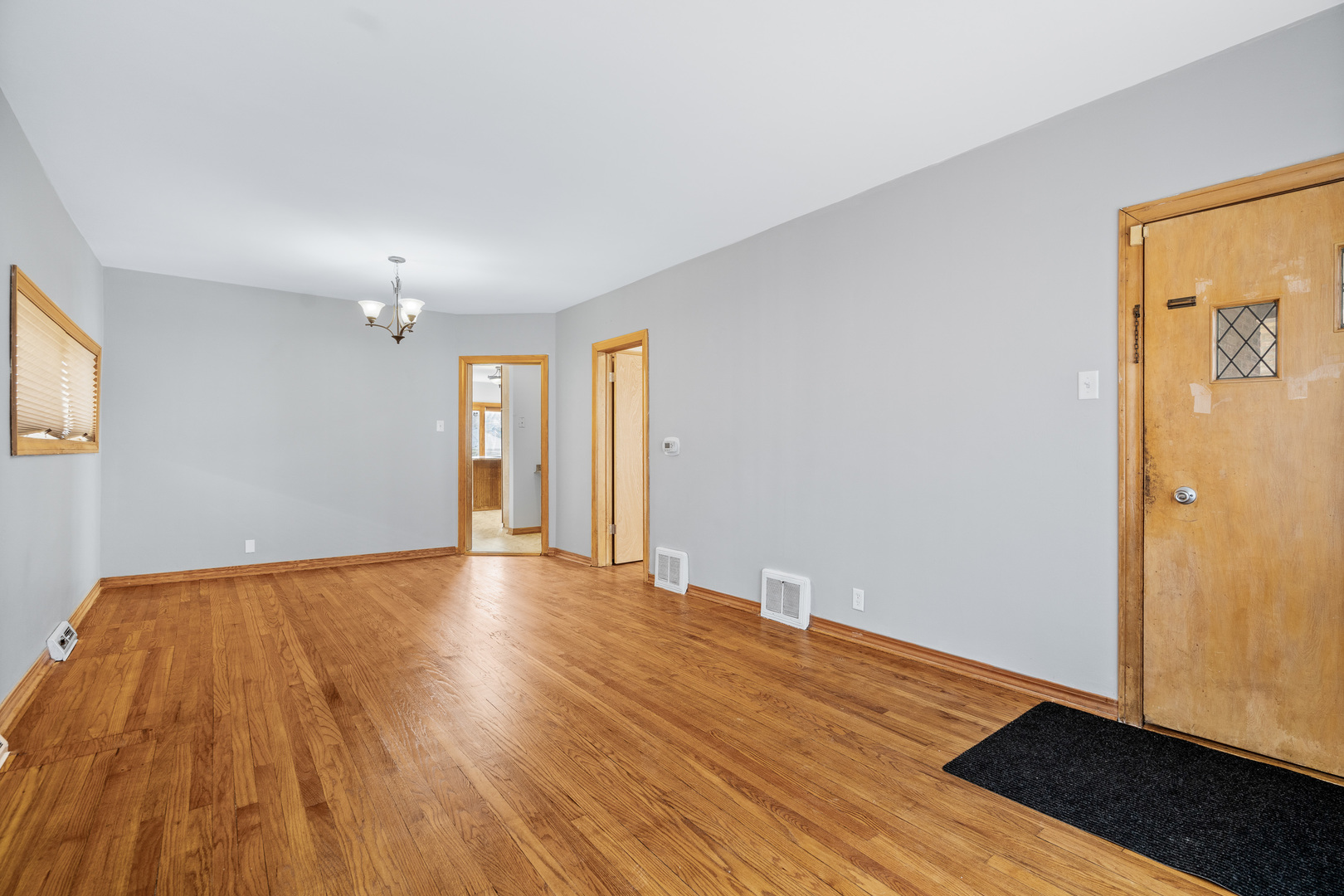 7845 45th Street Lyons, IL 60534 - Photo 4 of 31 a view of an empty room with wooden floor and a window