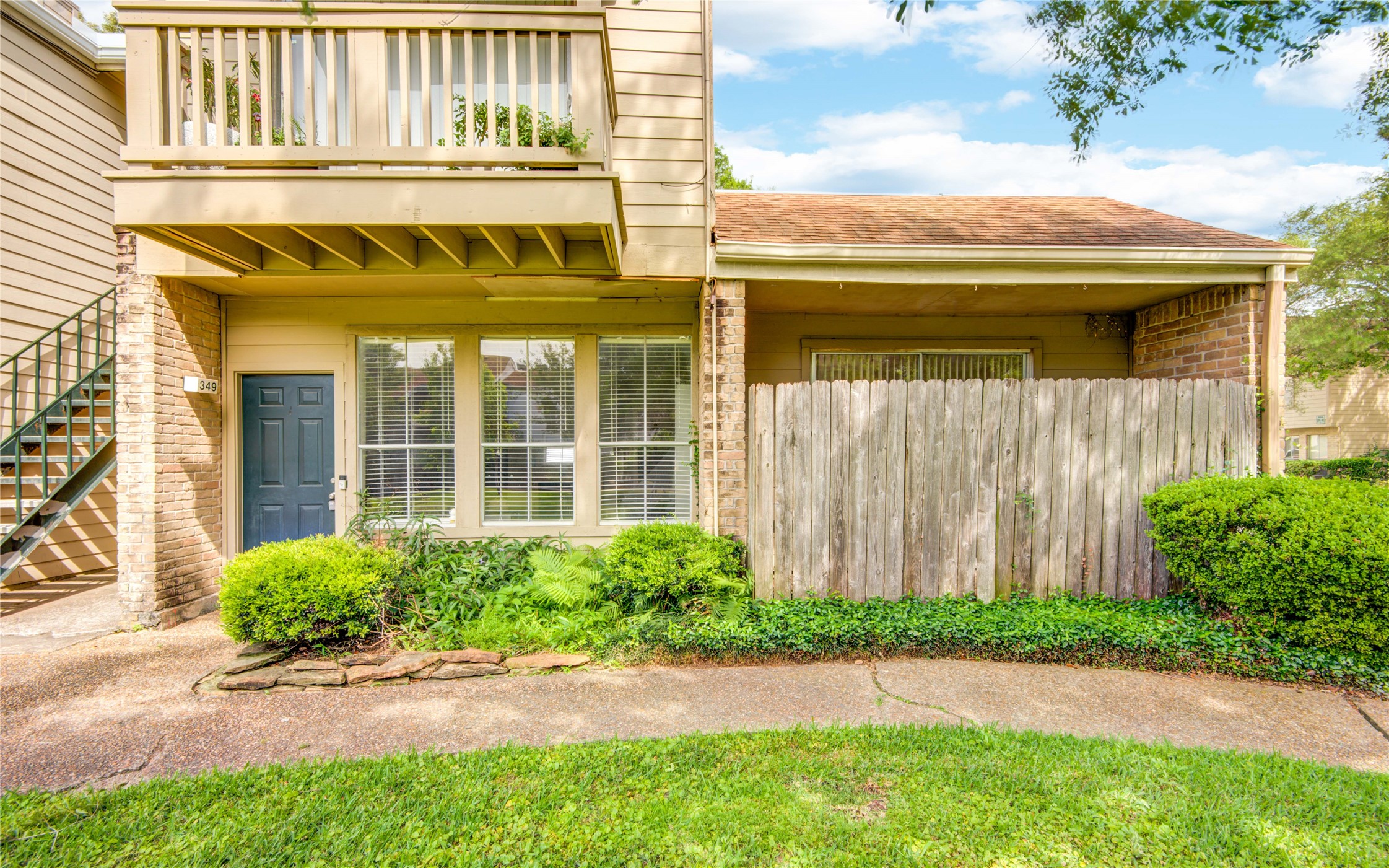2100 Tanglewilde Street, Unit 349 Houston, TX 77063 - Photo 1 of 29 a view of a house with a yard and plants