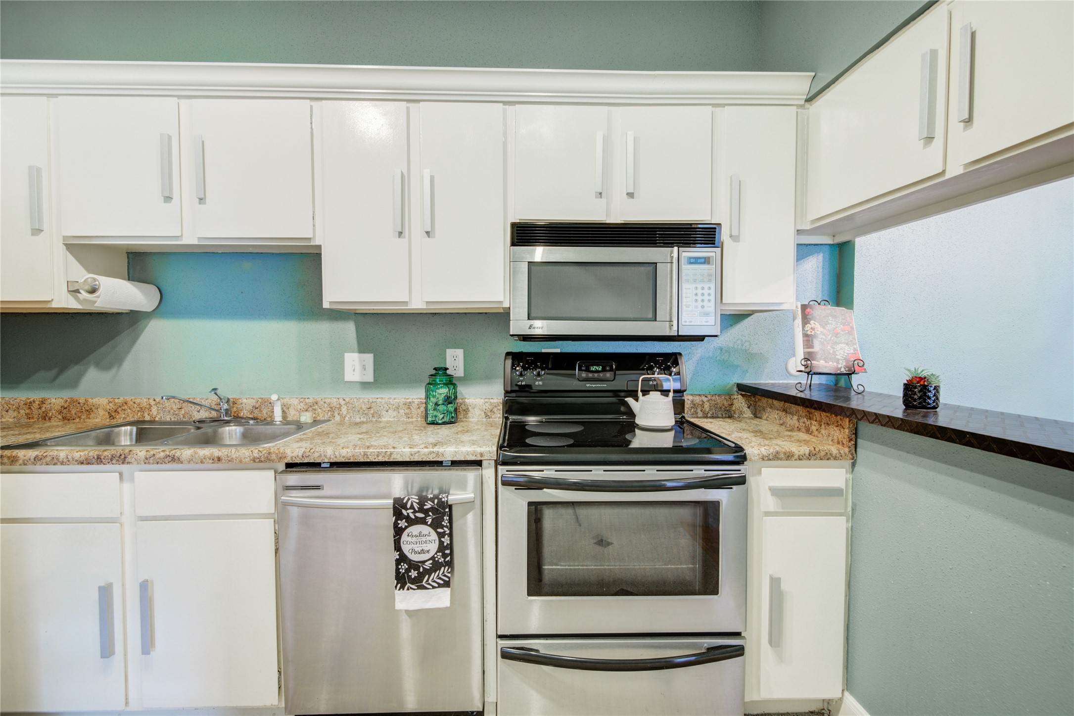 2100 Tanglewilde Street, Unit 349 Houston, TX 77063 - Photo 15 of 29 a kitchen with granite countertop white cabinets and stainless steel appliances