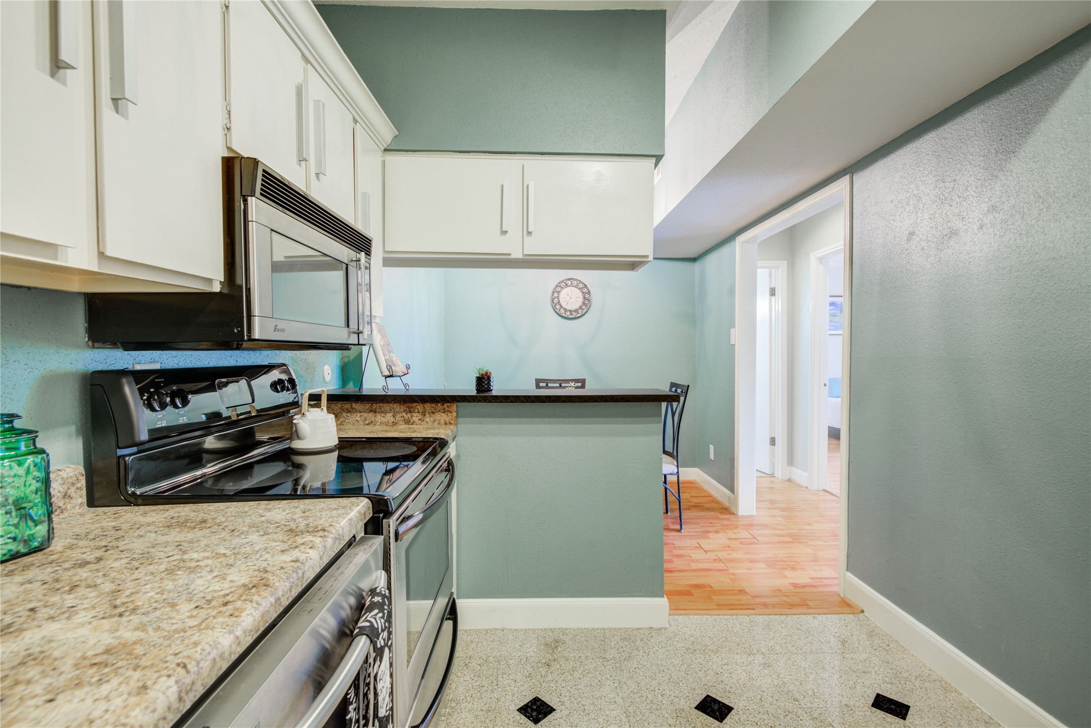 2100 Tanglewilde Street, Unit 349 Houston, TX 77063 - Photo 16 of 29 a kitchen with stainless steel appliances granite countertop a stove a sink and a refrigerator