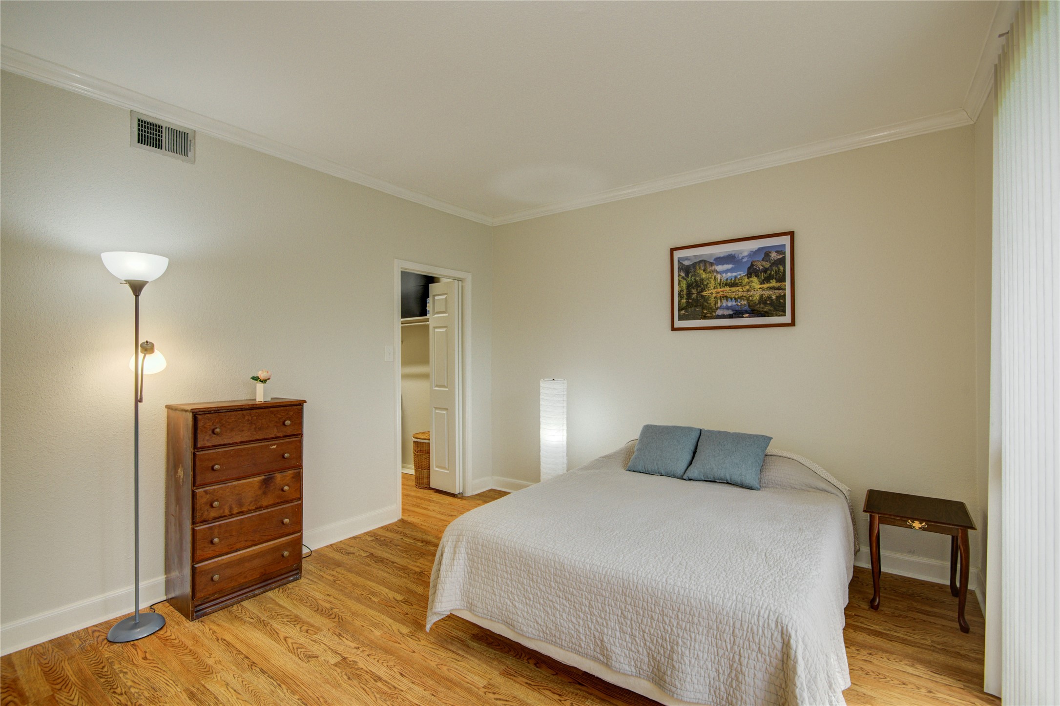 2100 Tanglewilde Street, Unit 349 Houston, TX 77063 - Photo 19 of 29 a bedroom with a bed and wooden floor