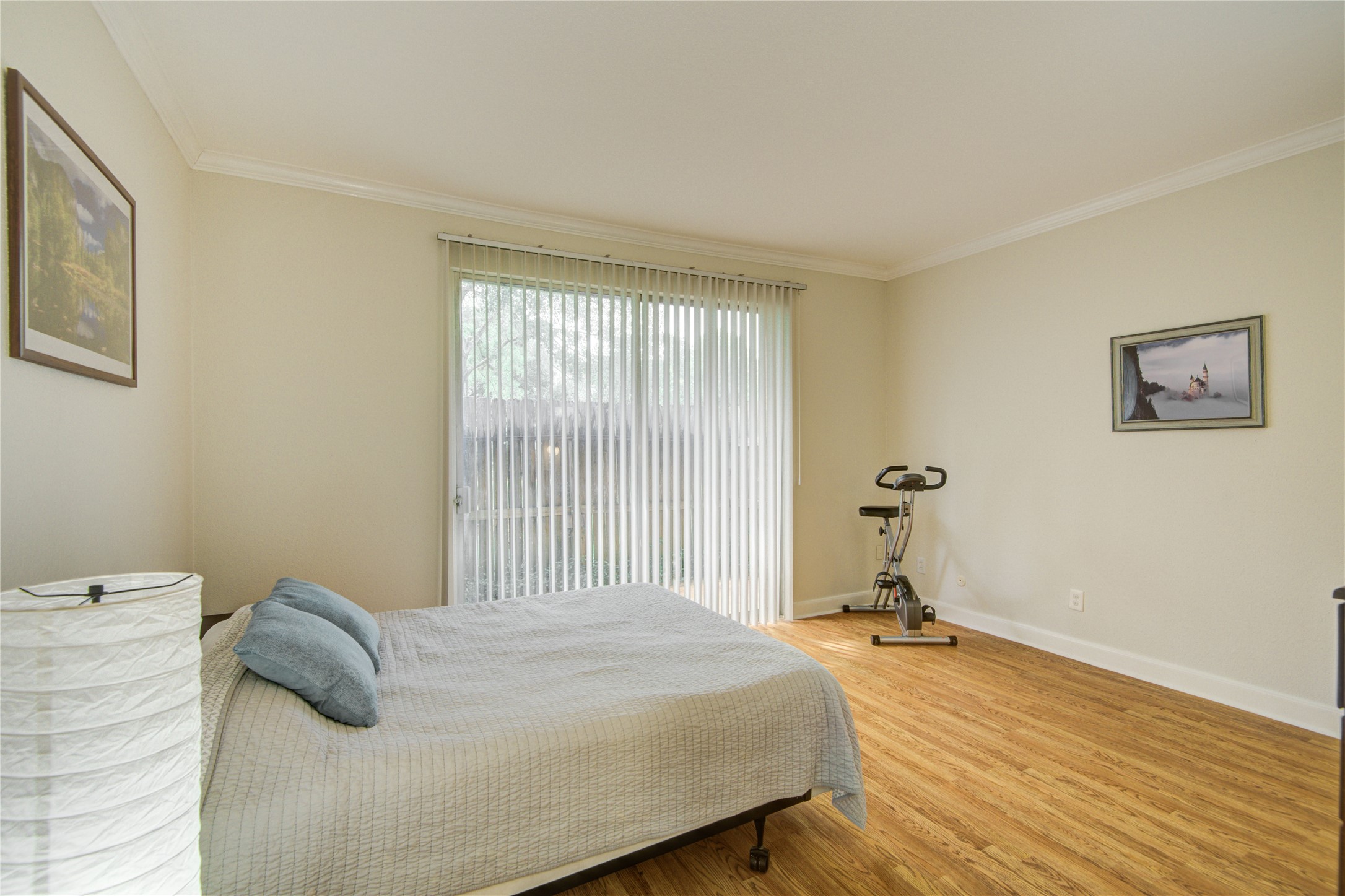 2100 Tanglewilde Street, Unit 349 Houston, TX 77063 - Photo 21 of 29 a bedroom with a bed and wooden floor