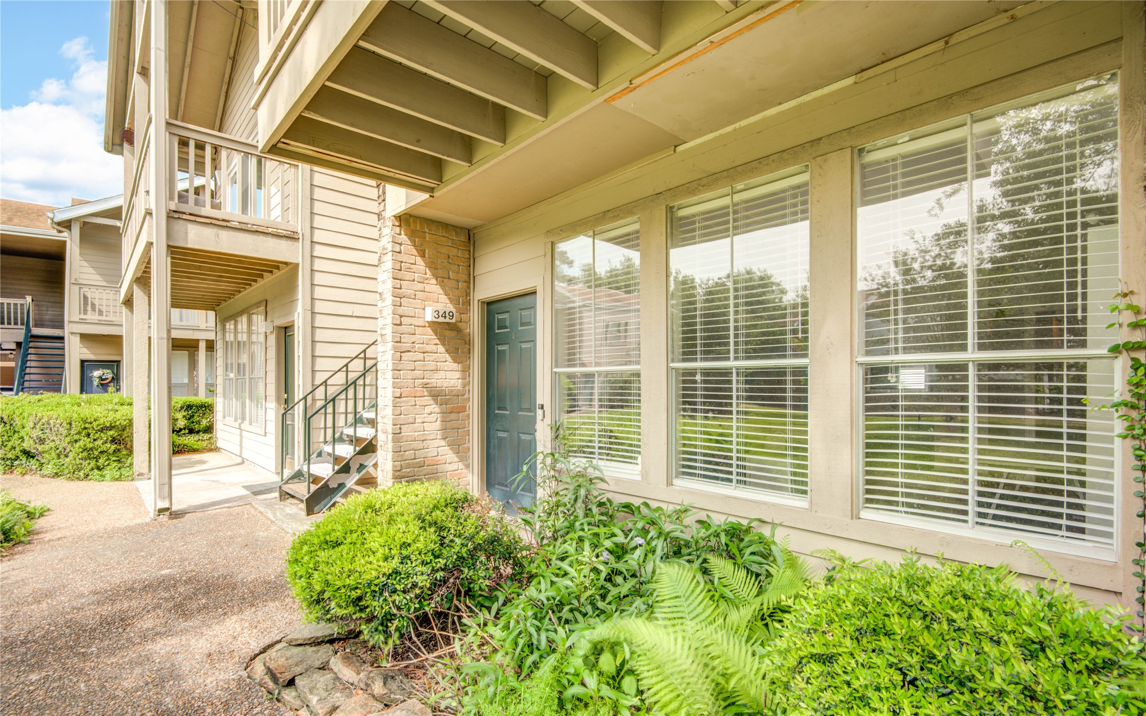 2100 Tanglewilde Street, Unit 349 Houston, TX 77063 - Photo 3 of 29 a view of a house with large windows and plants