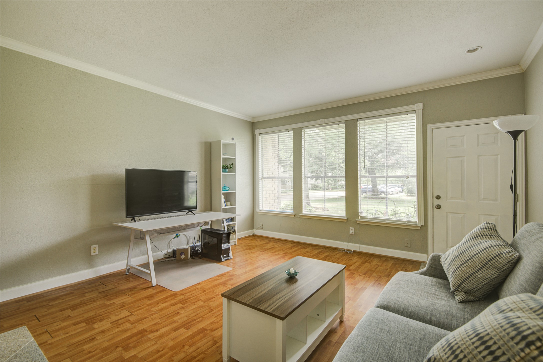 2100 Tanglewilde Street, Unit 349 Houston, TX 77063 - Photo 8 of 29 a living room with furniture and a flat screen tv