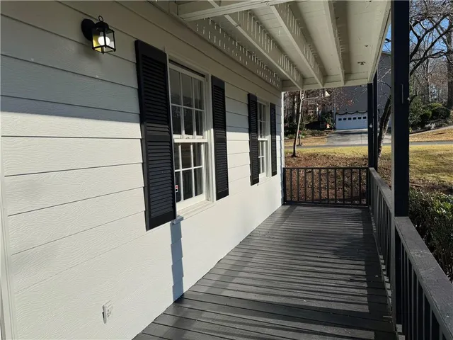 a view of empty room with wooden floor and window