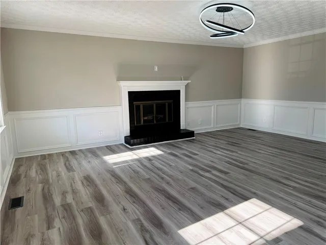 a kitchen with stainless steel appliances granite countertop a stove a refrigerator and a sink with wooden floors