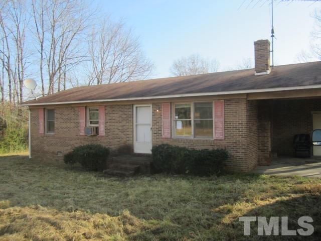 9276 Dirgie Mine Road Roxboro, NC 27574 - Photo 1 of 14 a front view of a house with garden