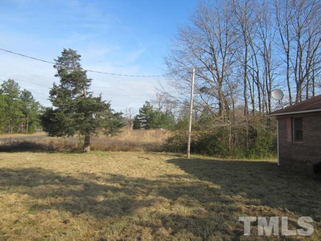 9276 Dirgie Mine Road Roxboro, NC 27574 - Photo 4 of 14 a view of a field with trees in the background
