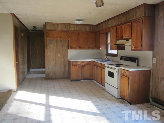 9276 Dirgie Mine Road Roxboro, NC 27574 - Photo 7 of 14 a kitchen with a stove a sink and a microwave
