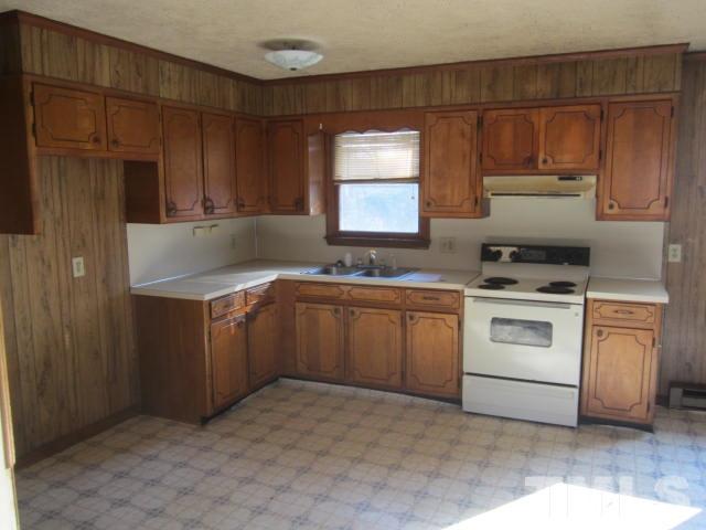 9276 Dirgie Mine Road Roxboro, NC 27574 - Photo 9 of 14 a kitchen with a stove sink and cabinets