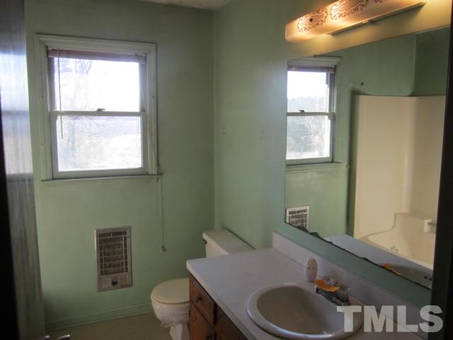 9276 Dirgie Mine Road Roxboro, NC 27574 - Photo 10 of 14 a bathroom with a sink toilet and mirror